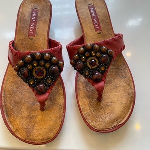 Red /rust colored thong sandals .